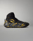 Side view of a black Batman wrestling shoe fitted with RUDIS black and yellow wrestling shoe covers.