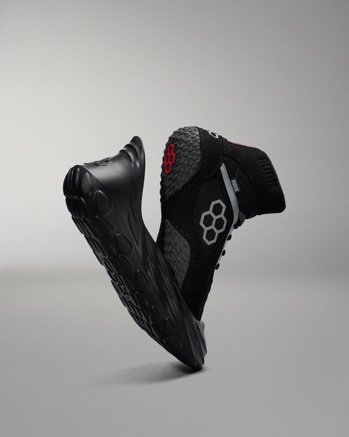 Black athletic wrestling shoe sole cover, with a wrestling shoe with a red logo on a gray background