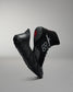 Black athletic wrestling shoe sole cover, with a wrestling shoe with a red logo on a gray background