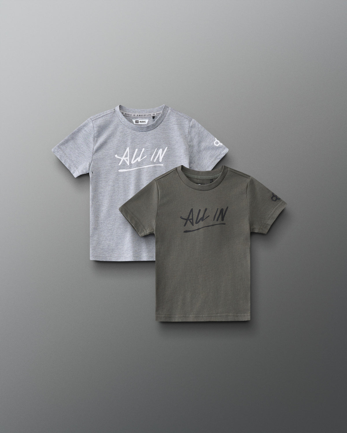 Front view of RUDIS Motto Scripted Toddler Elite Super Soft T-Shirt 2-Pack in olive and gray, featuring ALL IN chest graphics and RUDIS sleeve logos.