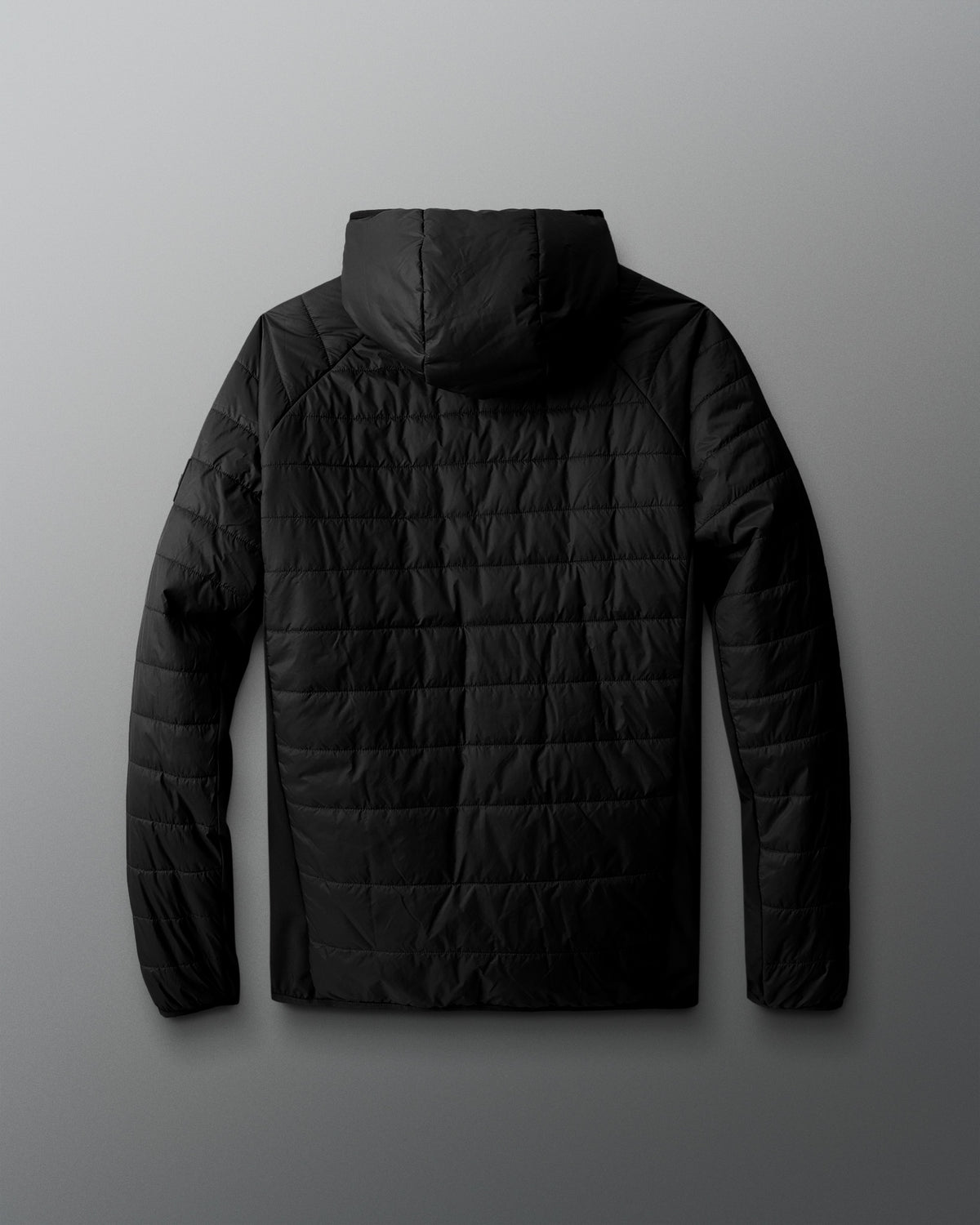 Black quilted jacket on a gray background