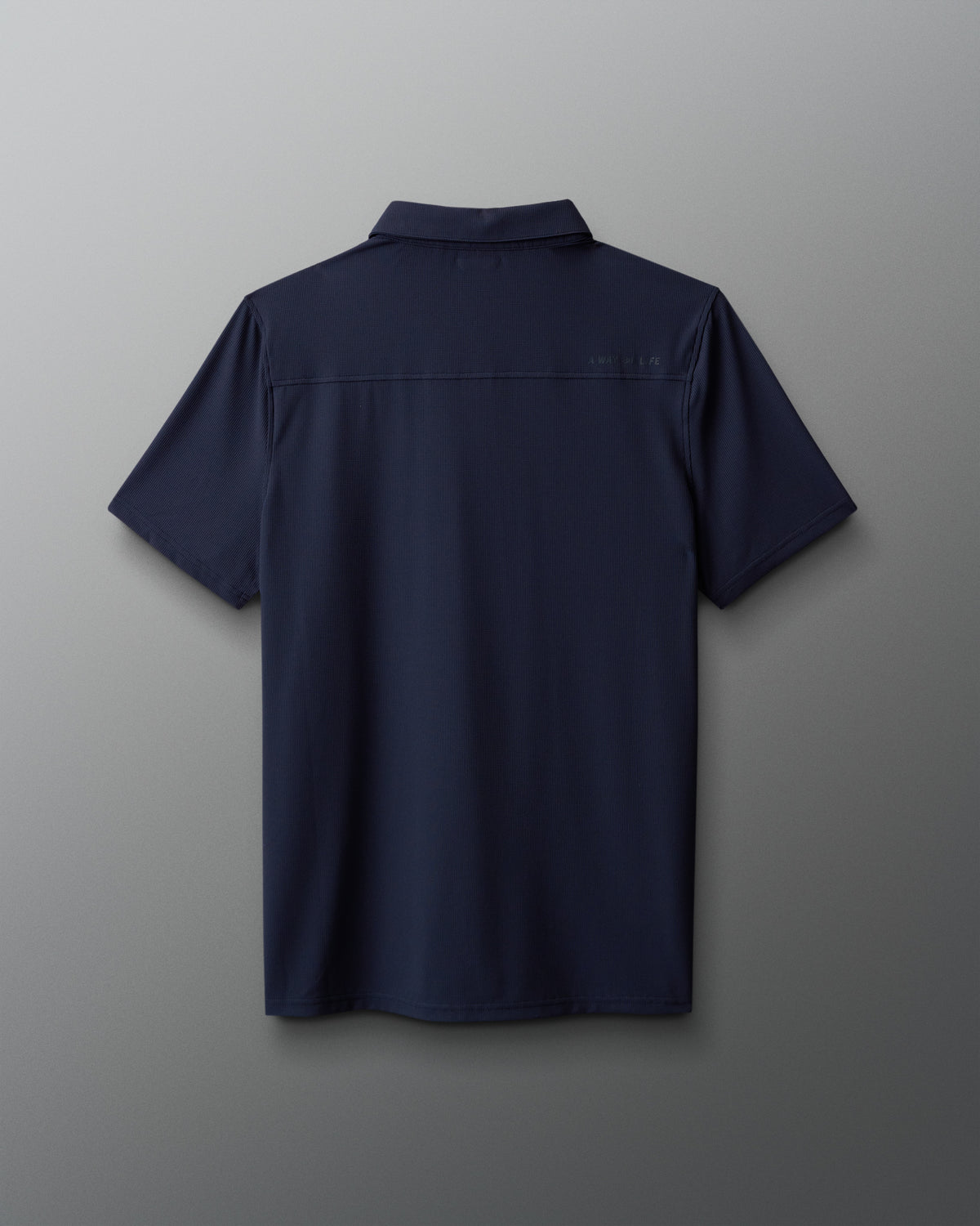 Navy blue shirt on a gray background