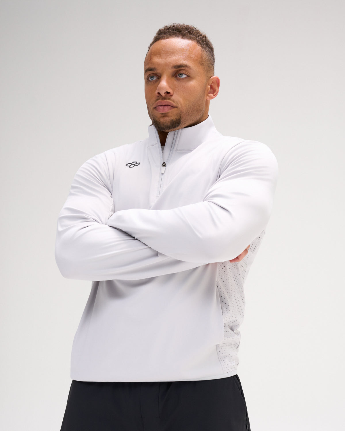 Model wearing the Lunar RUDIS Victory 1/4 Zip performance pullover with quarter-zip collar, RUDIS chest mark, and ventilated side panels.