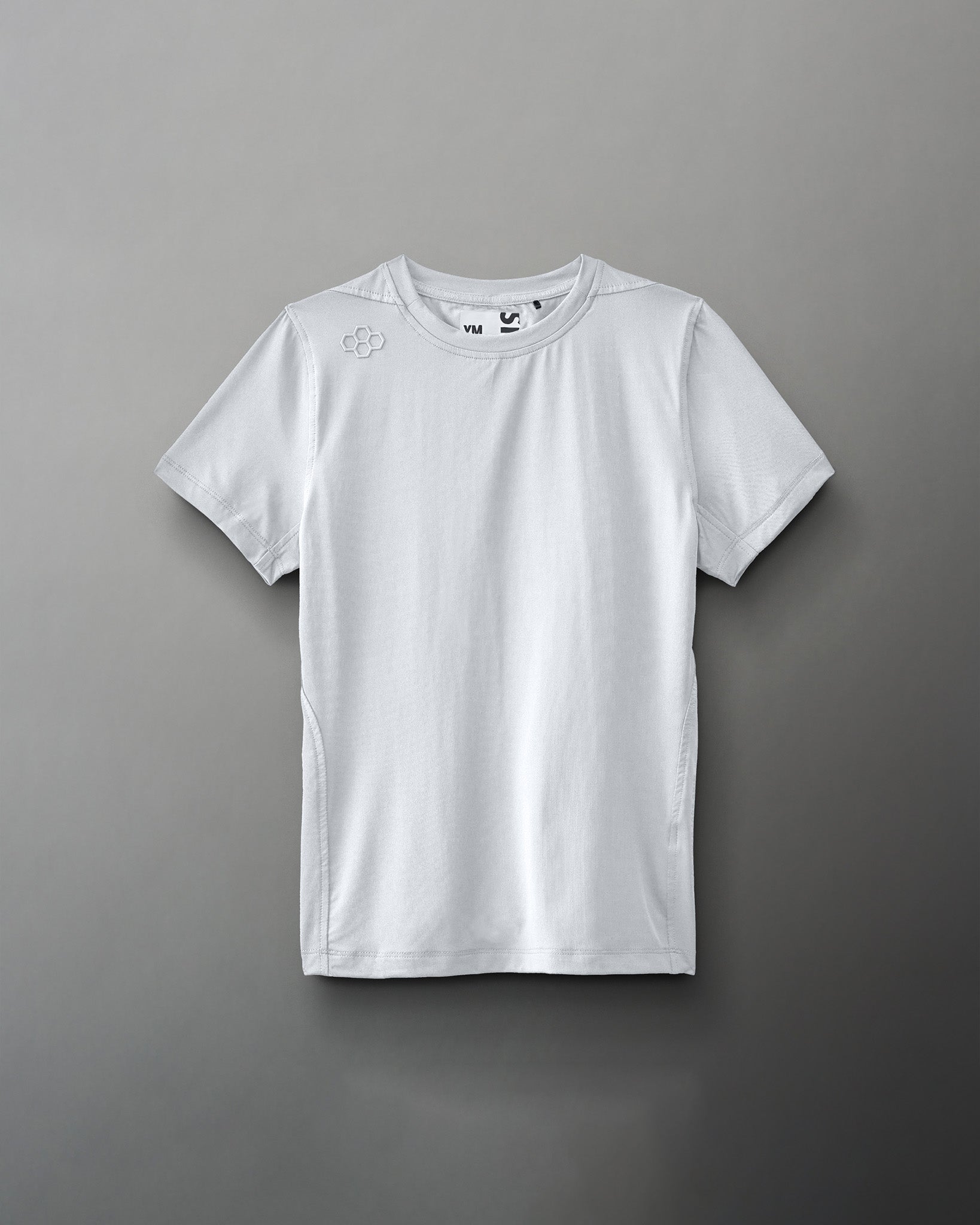 A light gray athletic shirt with a round neck and short sleeves features a subtle logo on the shoulder, designed for sports or casual use.