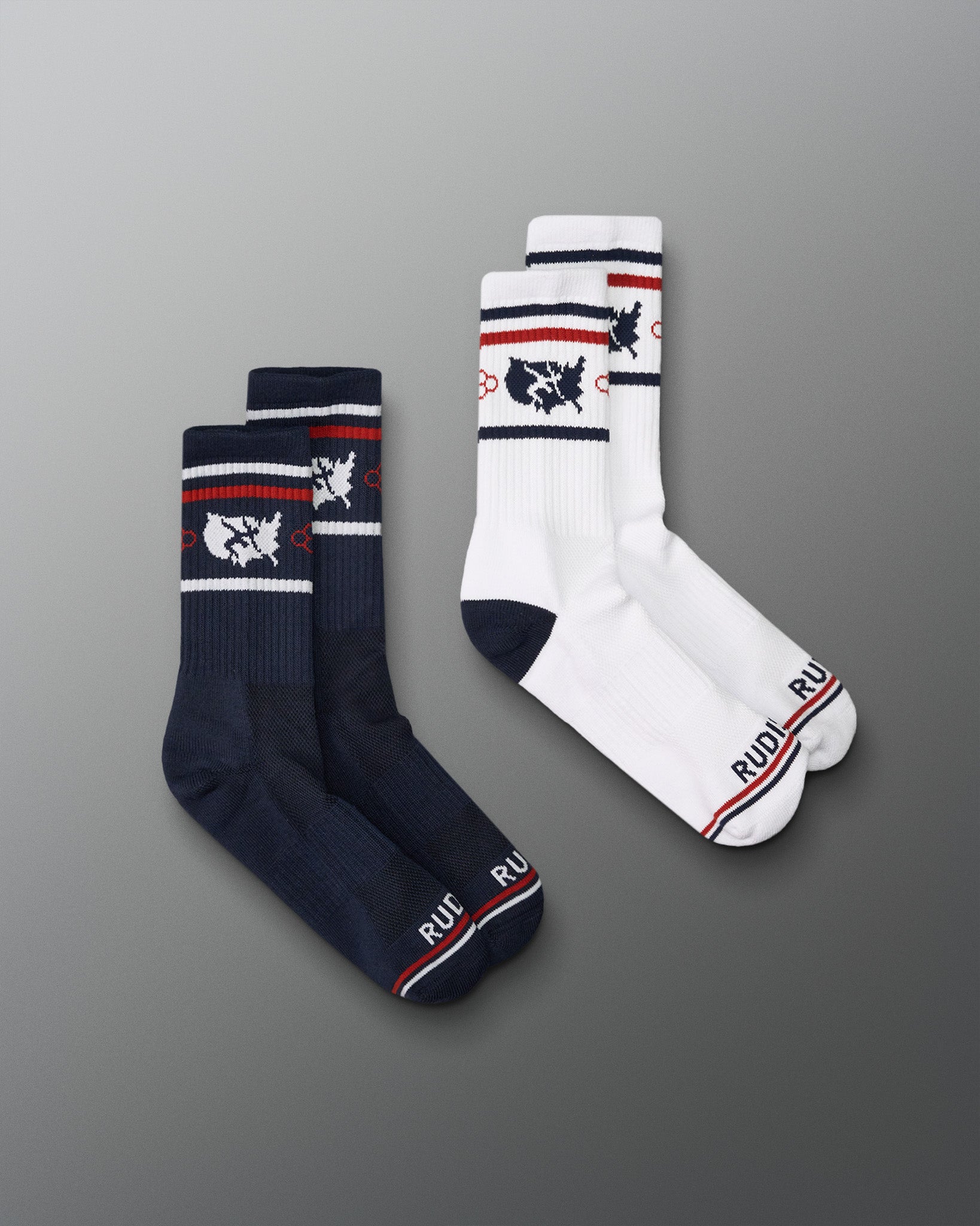 Two pairs of socks, one navy and one white, with brand logos on a gray background.
