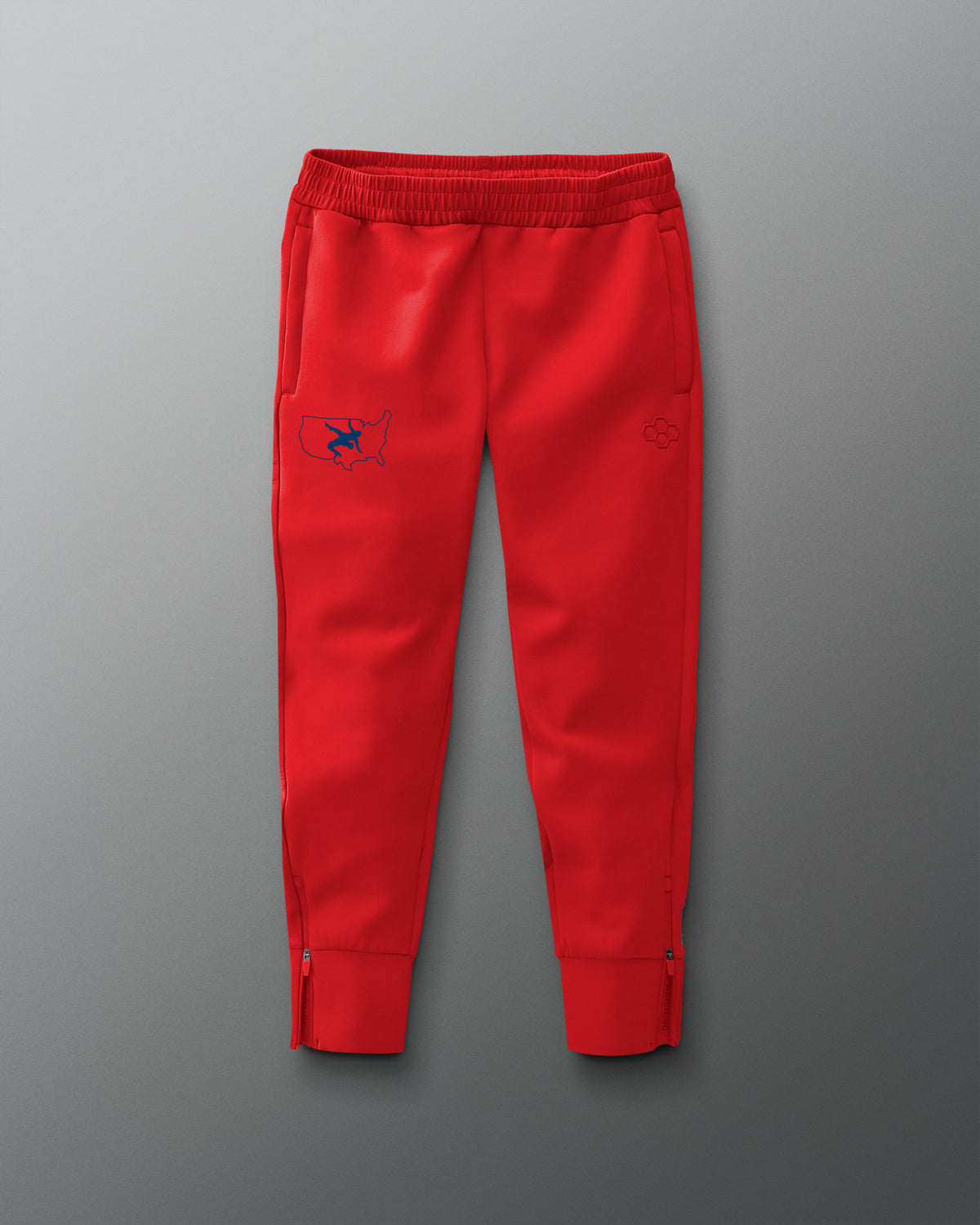Red jogger pants with a small logo on a gray background