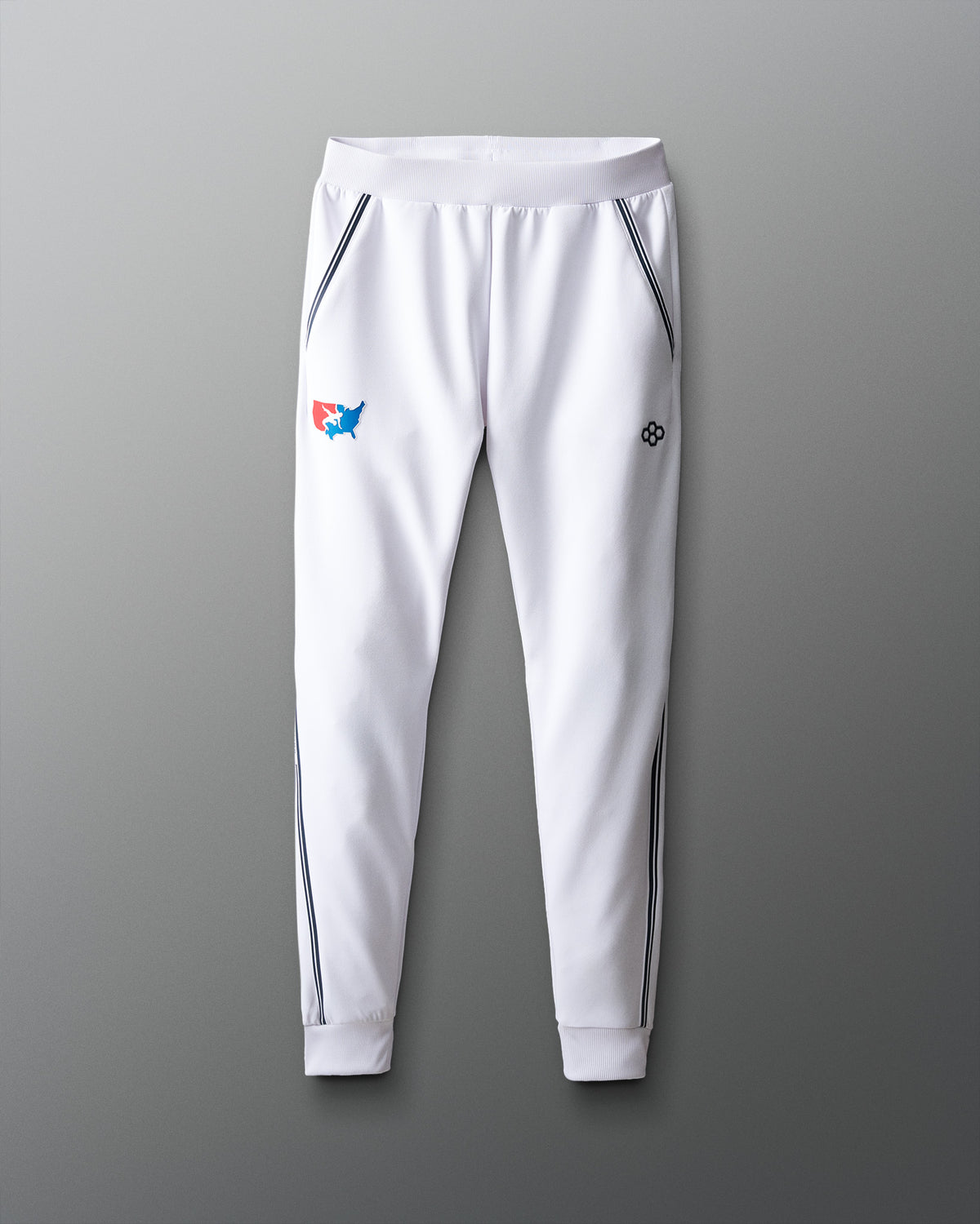 White jogger pants with logos on a gray background