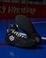 Black wrestling shoes with white accents on a blue mat background