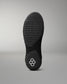 Black sole of a wrestling shoe with a brand logo on a gray background