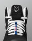 Black wrestling shoe with white laces and a logo on a gray background