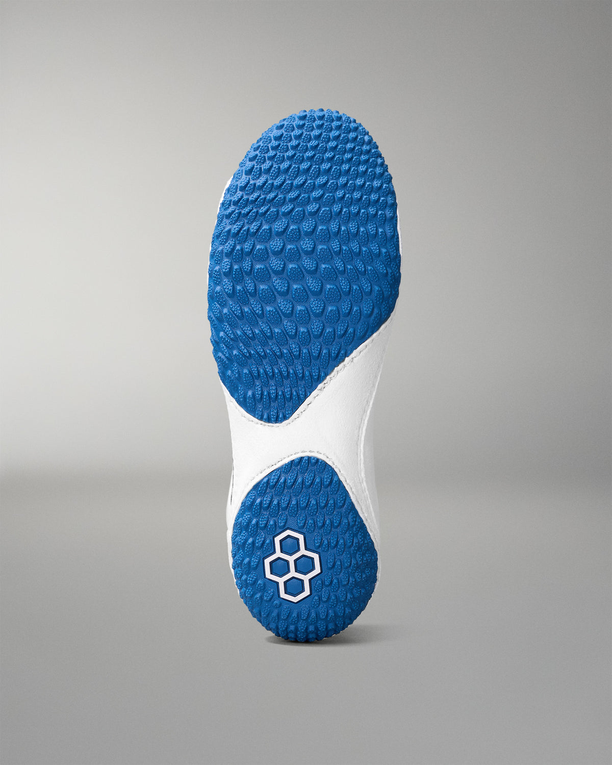 Close-up of a blue and white wrestling shoe sole on a gray background