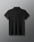 Black polo shirt on a gray background