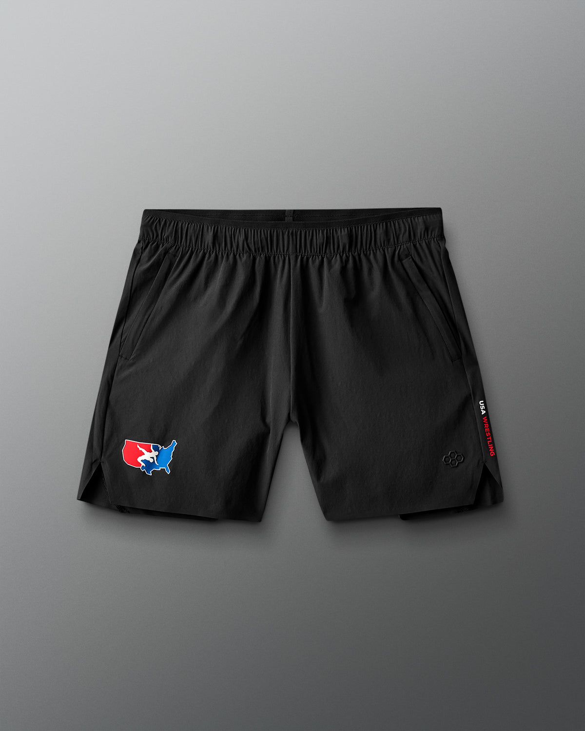 Black shorts with a USA Wrestling logo on a gray background