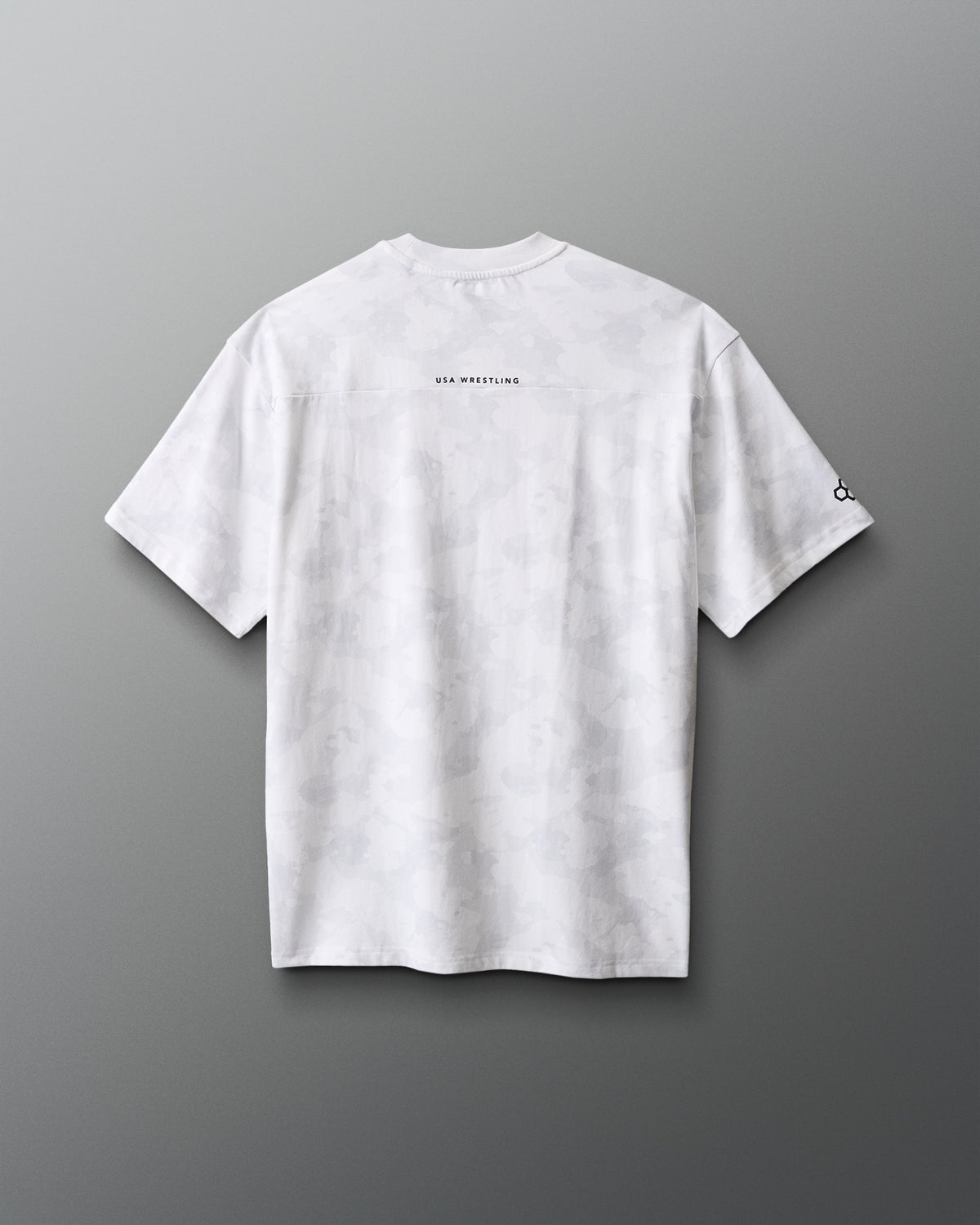 White t-shirt with text on the back against a gradient red to blue background