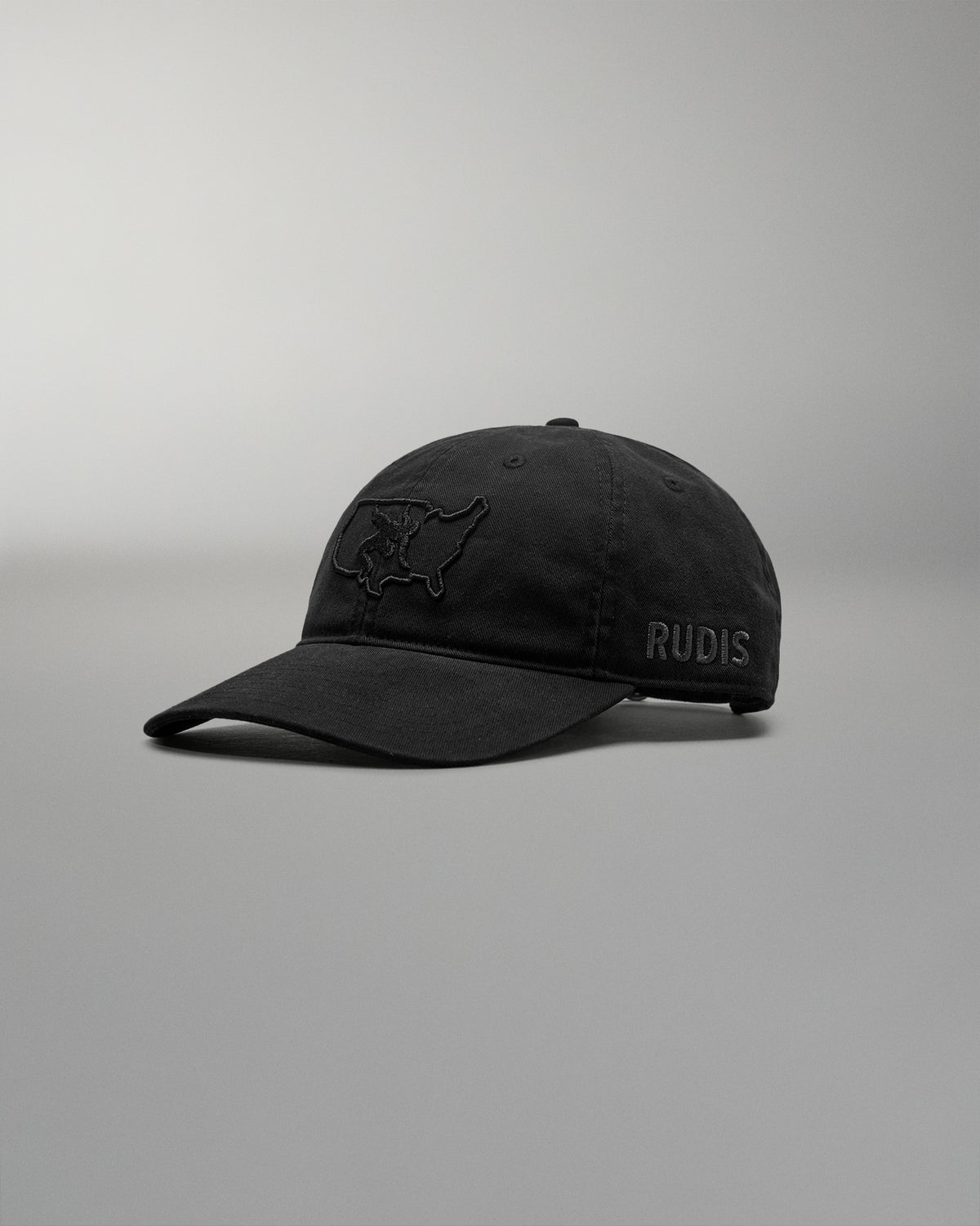 Black cap with 'RUDIS' logo on a gray background
