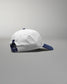 White cap with blue accents on a gray background