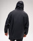 Rear view of a male model wearing the RUDIS Motion Windbreaker in Black with the hood up, showcasing its streamlined silhouette, full-length sleeves, and clean, minimalist back design.