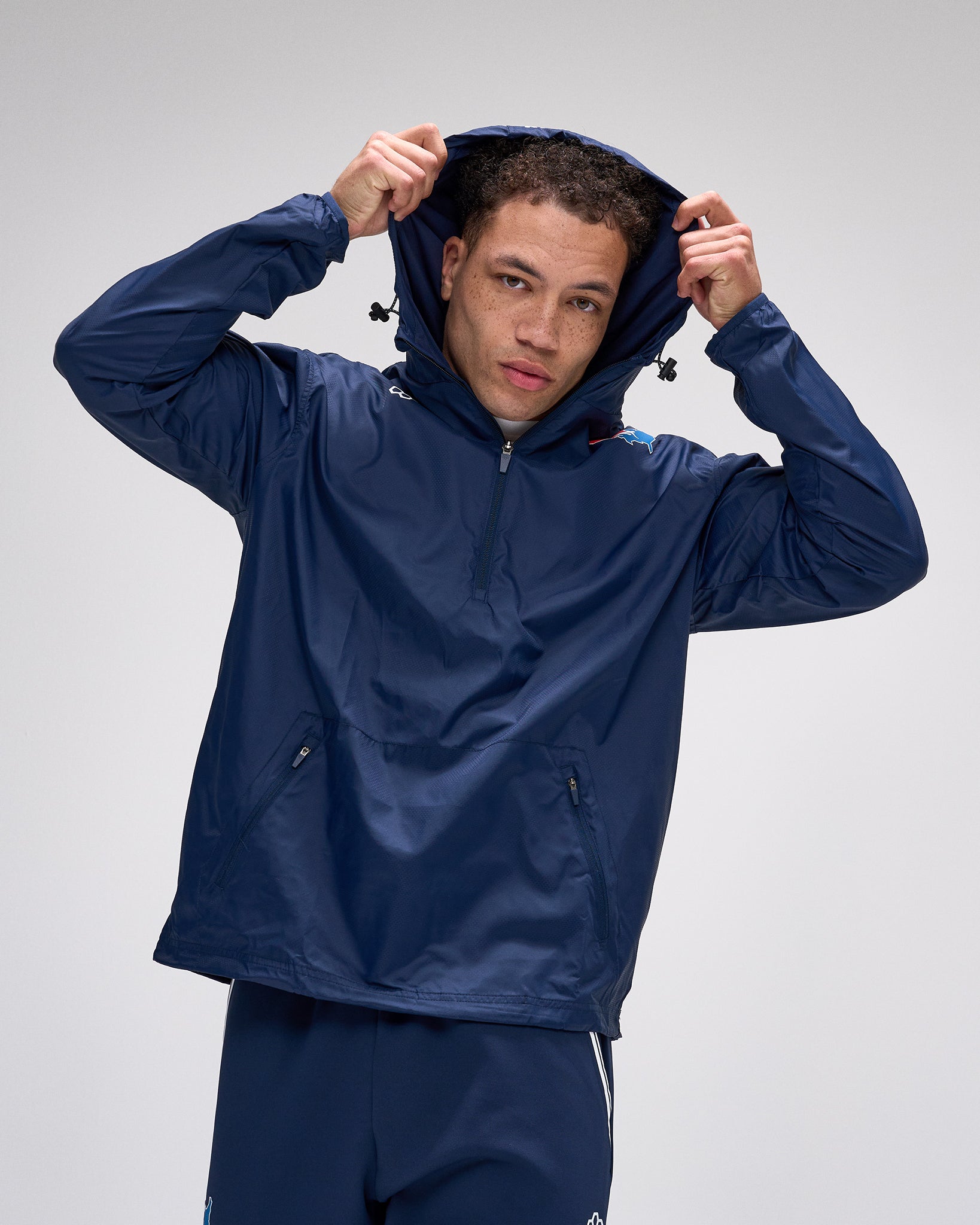 Person wearing a blue raincoat on a gray background