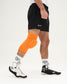 Person wearing an orange knee brace on a white background