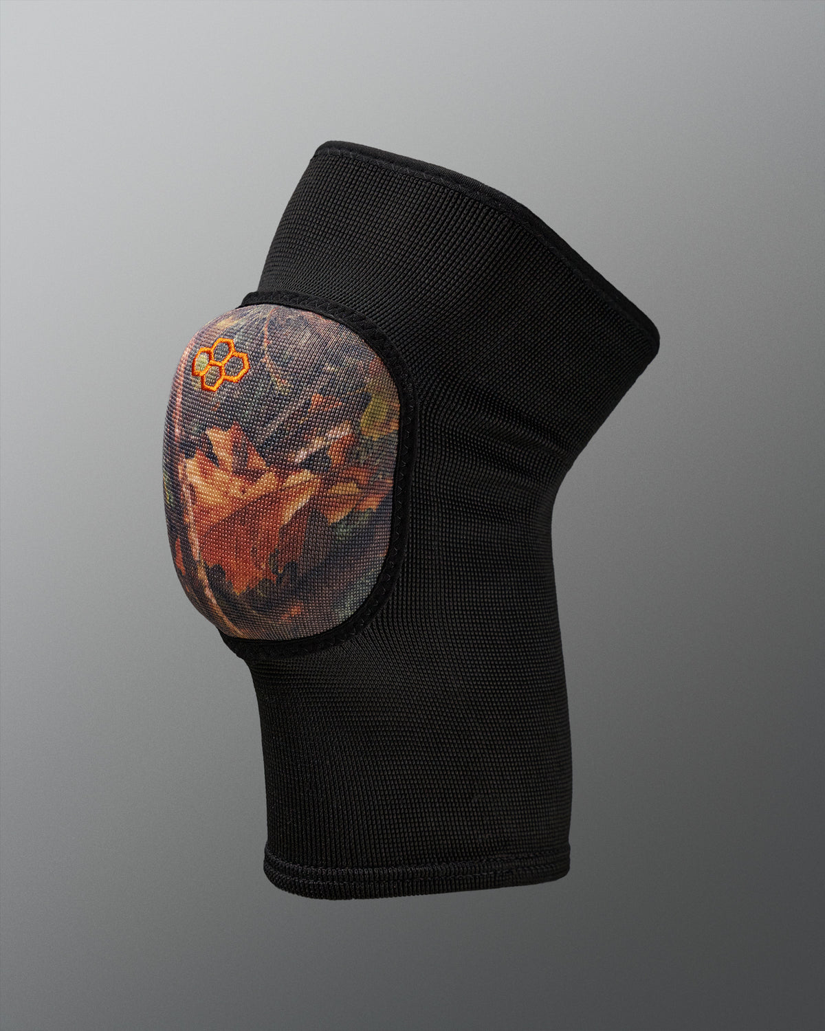 Black knee pad with a camo design on a gray background