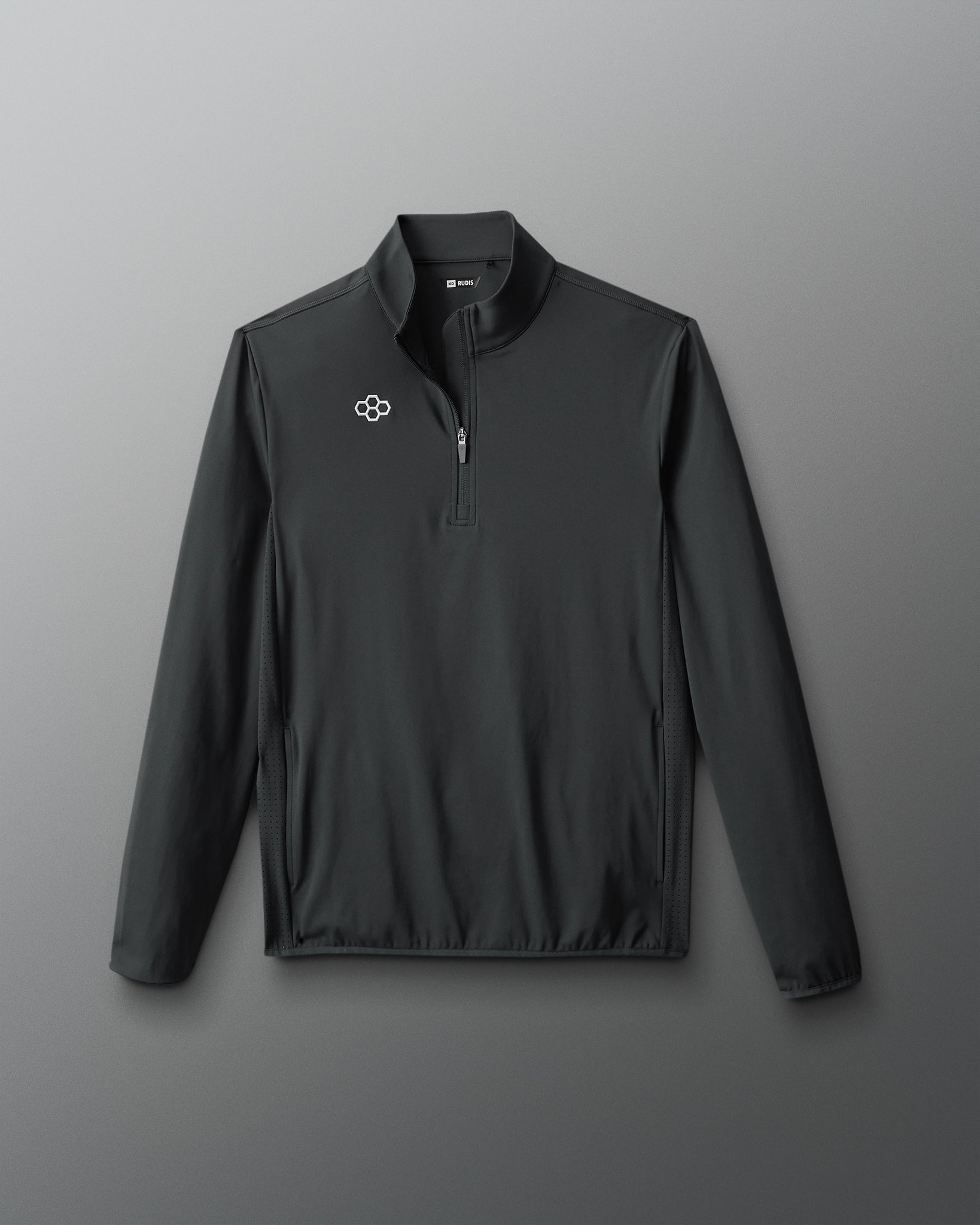 Front view of the RUDIS Victory 1/4 Zip in Carbon, showcasing the quarter-zip closure, stand collar, white RUDIS chest logo, perforated side panels, and long sleeves.