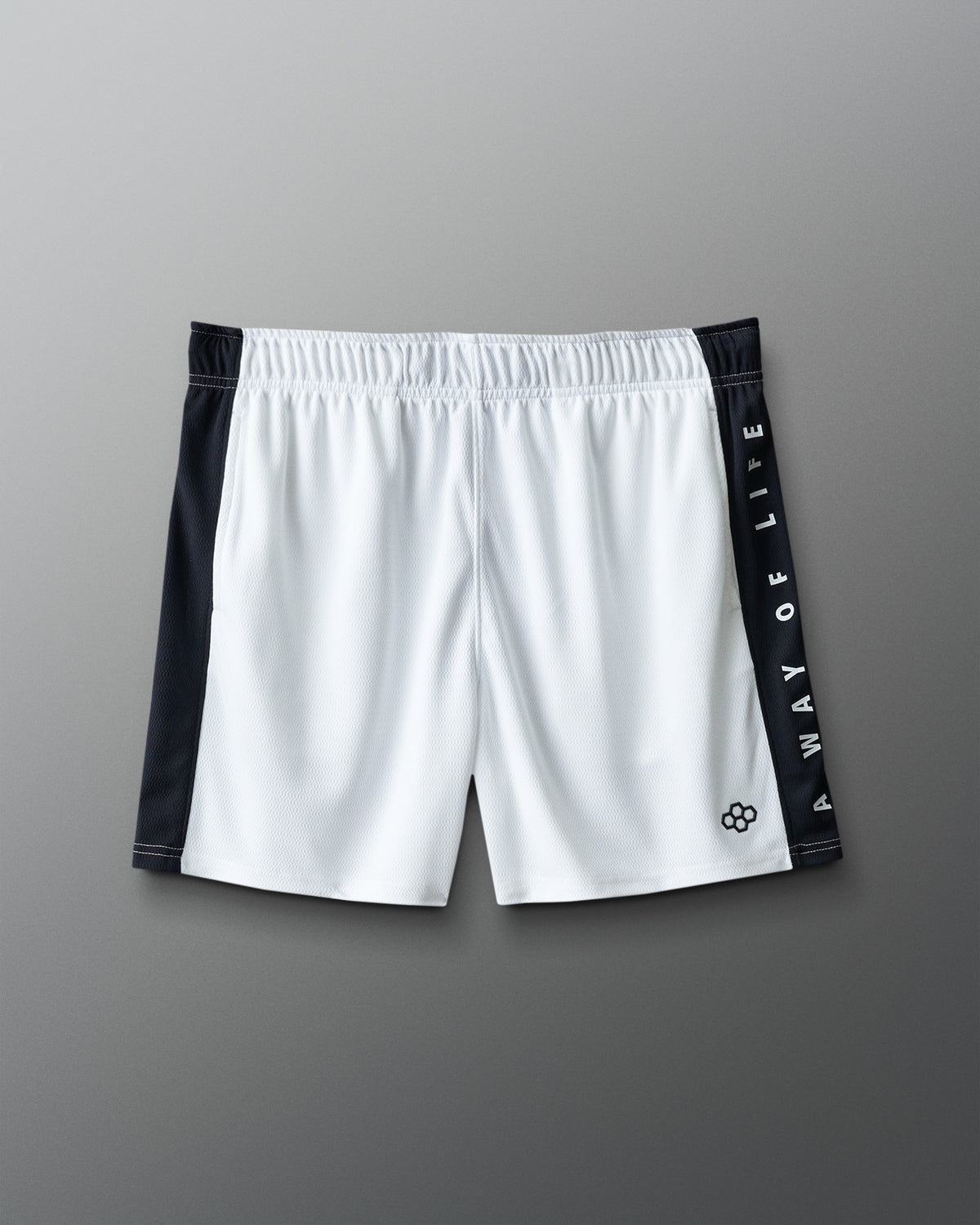 White shorts with black side panels and branding on a gray background