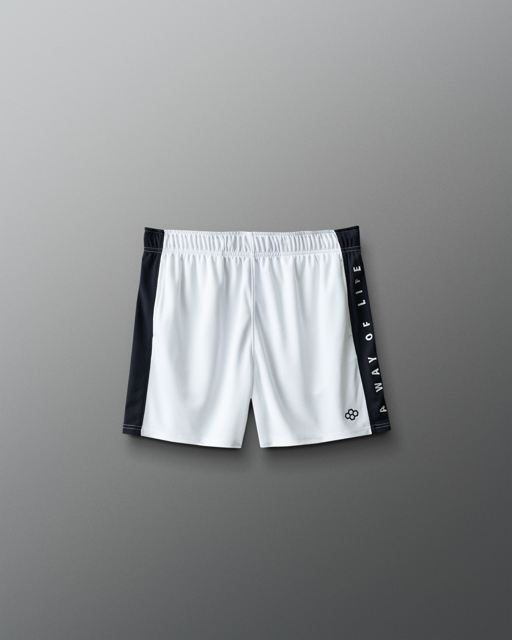 White shorts with black side panels on a gray background