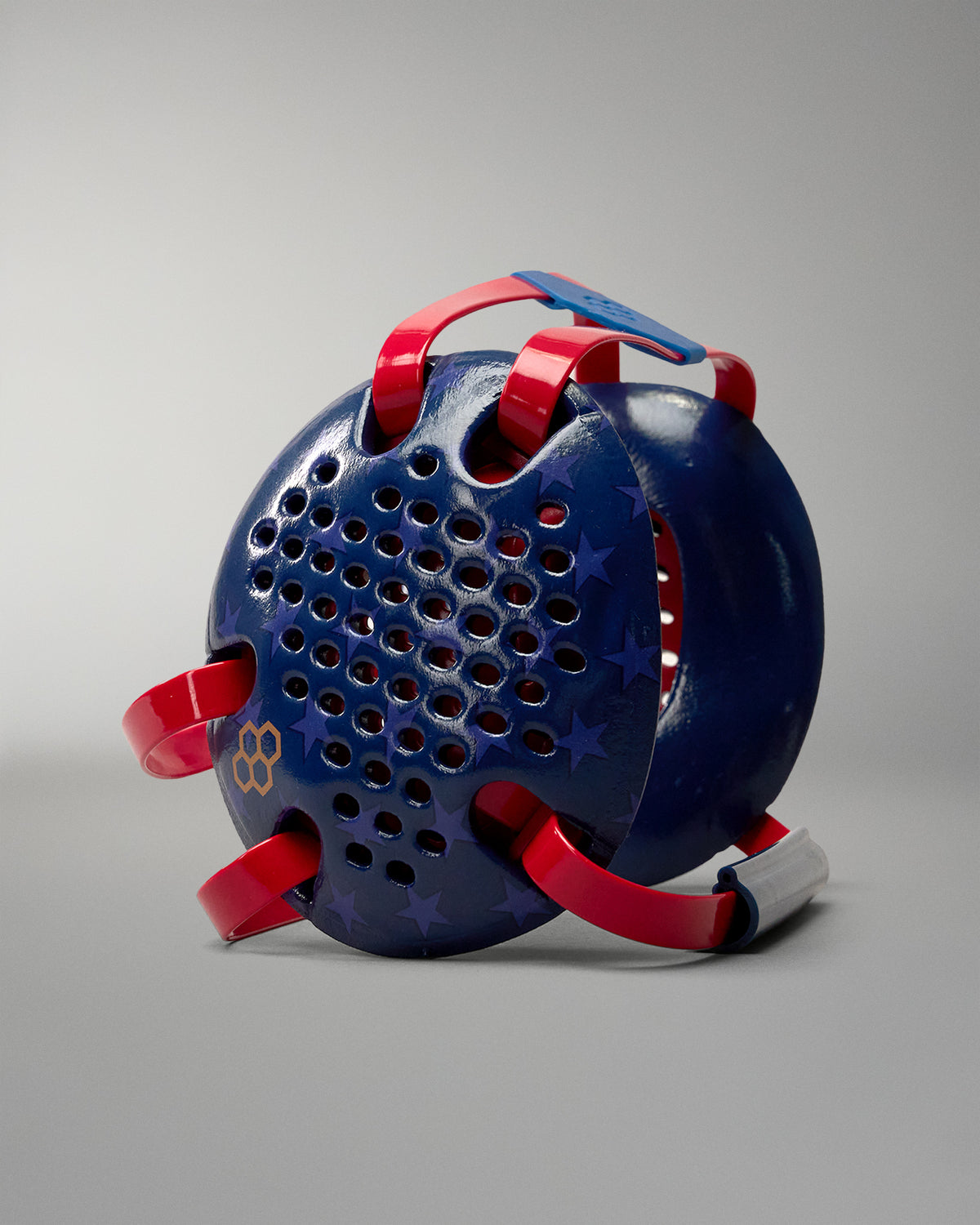 RUDIS Wonder Woman Elite Airflow Wrestling Headgear featuring navy blue ear guards with star graphics, red straps, ventilation holes and gold RUDIS logo.
