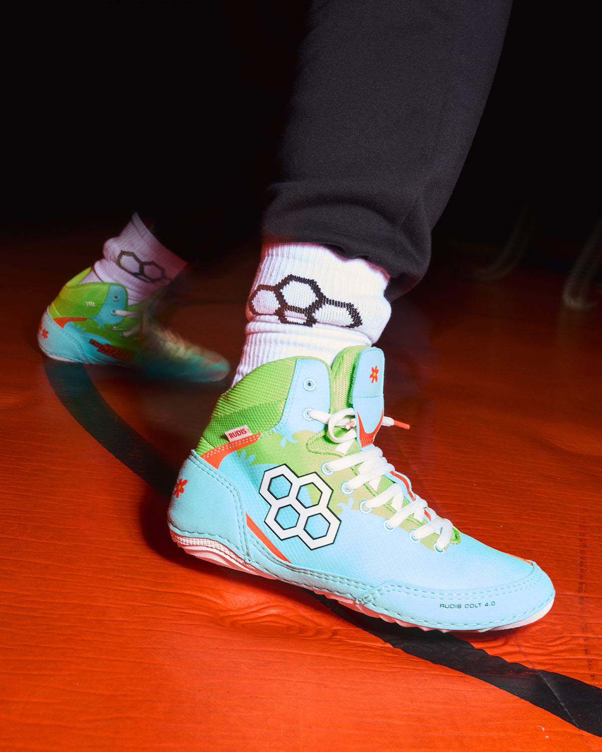 RUDIS Scooby-Doo Colt 4.0 adult wrestling shoes worn on foot, featuring turquoise uppers, green ankle support, white laces, and Mystery Machine-inspired graphics.