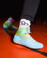 RUDIS Scooby-Doo Colt 4.0 adult wrestling shoes worn on foot, featuring turquoise uppers, green ankle support, white laces, and Mystery Machine-inspired graphics.