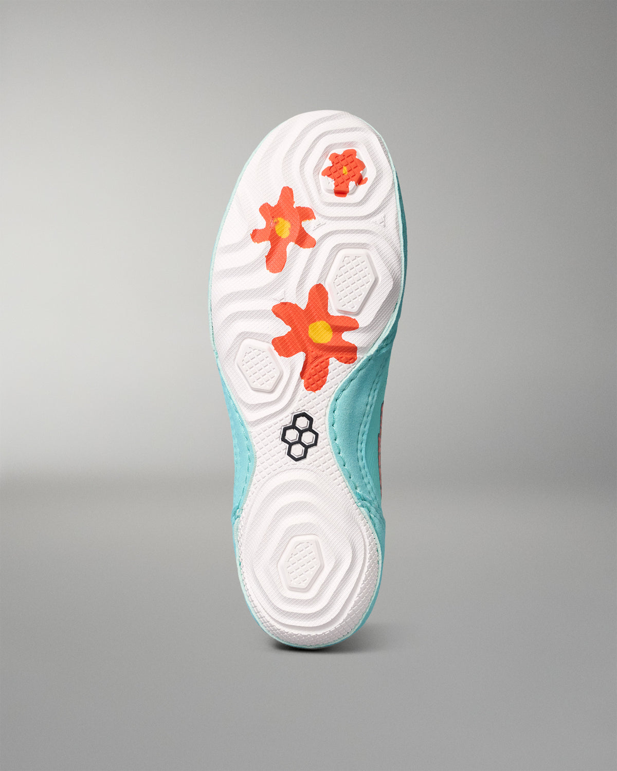 Bottom view of the RUDIS Scooby-Doo Colt 4.0 wrestling shoe, showing a white textured outsole with orange flower-shaped traction elements and black RUDIS logo.