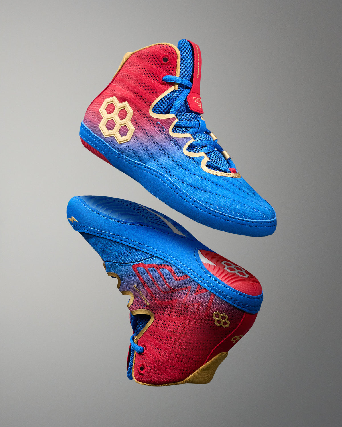 Angled view of RUDIS Wonder Woman Hildebrandt 2.0 women's wrestling shoes, showcasing blue and red uppers, gold RUDIS logos, blue laces and Wonder Woman graphics.