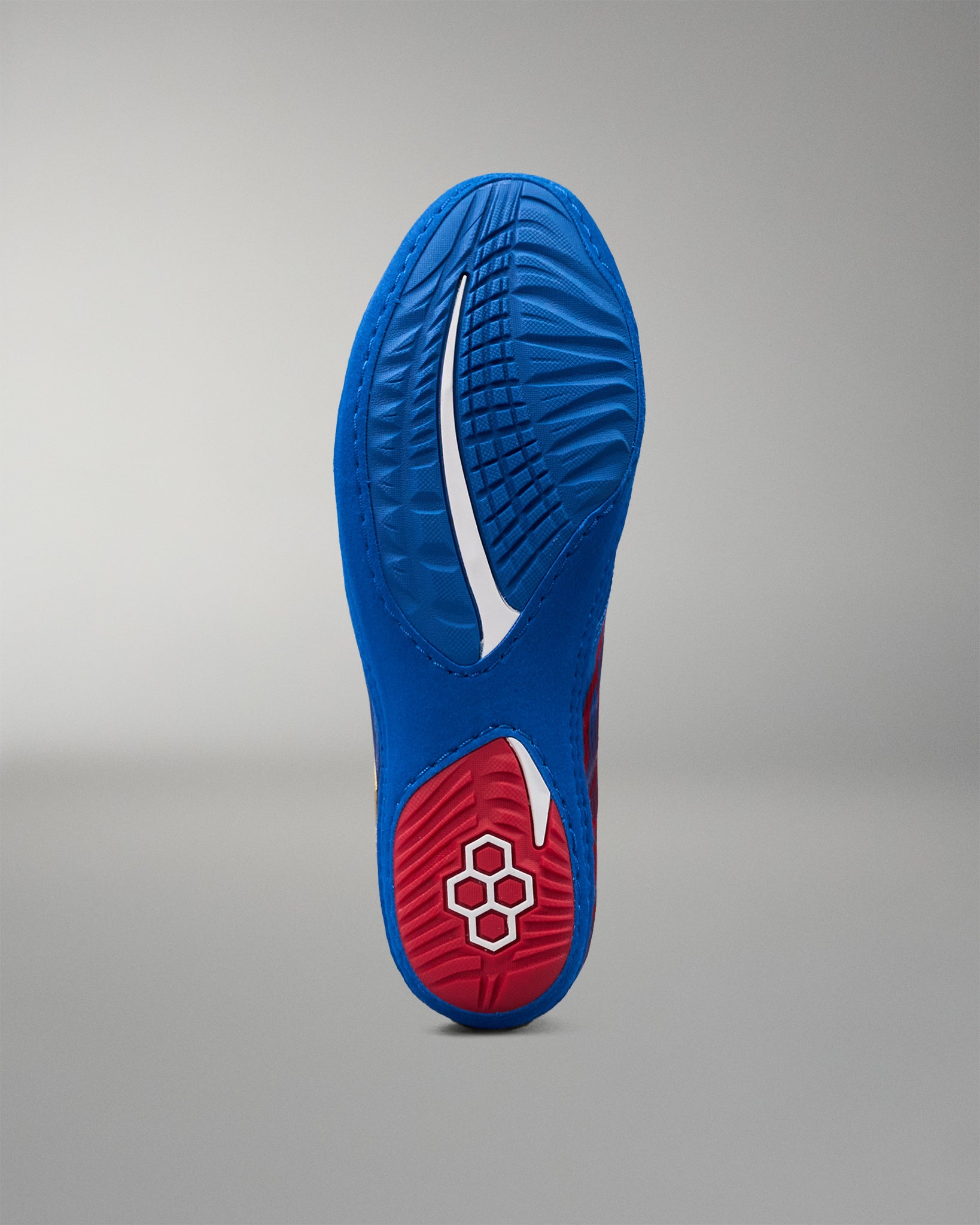 Bottom view of RUDIS Wonder Woman Hildebrandt 2.0 women's wrestling shoe, highlighting the textured blue and red outsole, traction pattern and RUDIS logo.