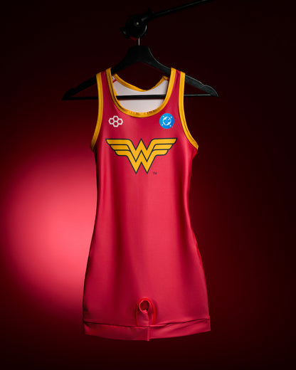 RUDIS Wonder Woman Logo Women's Elite 2.0 Wrestling Singlet in red with yellow trim, iconic Wonder Woman chest emblem and DC Comics branding, displayed on a hanger against a red background.
