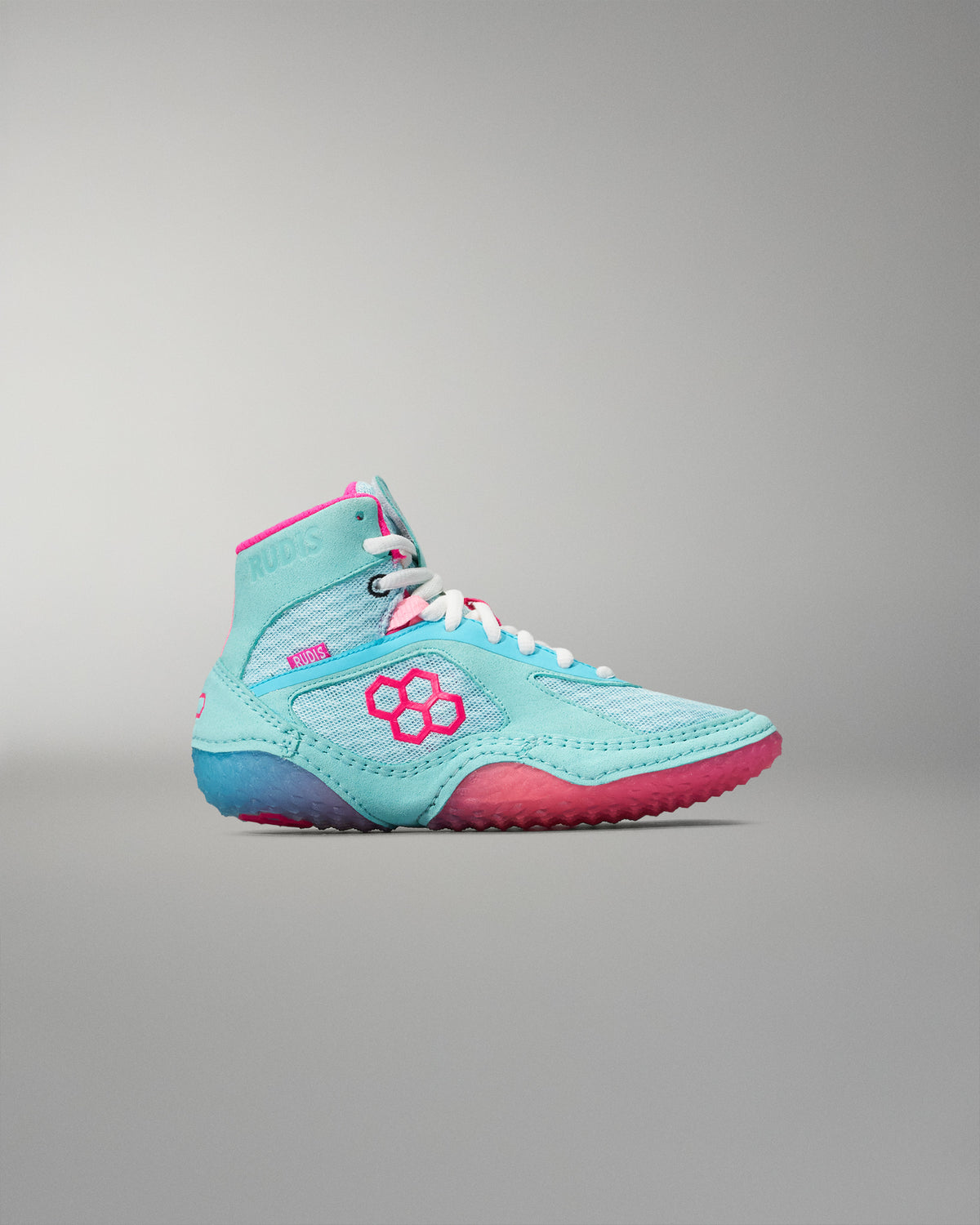 Turquoise and pink wrestling shoe on a gray background