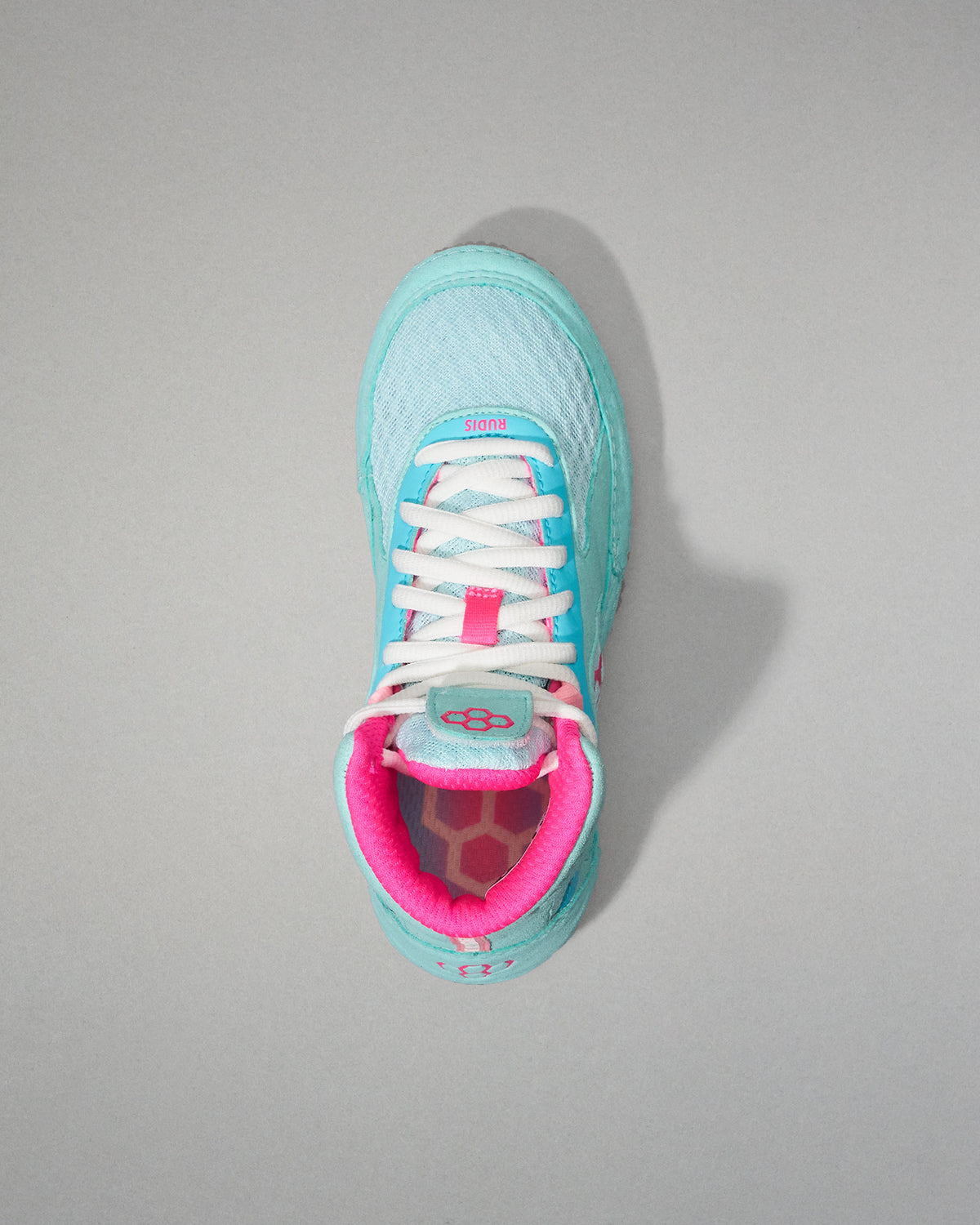 Light blue Wrestling Shoe with pink interior on a gray background
