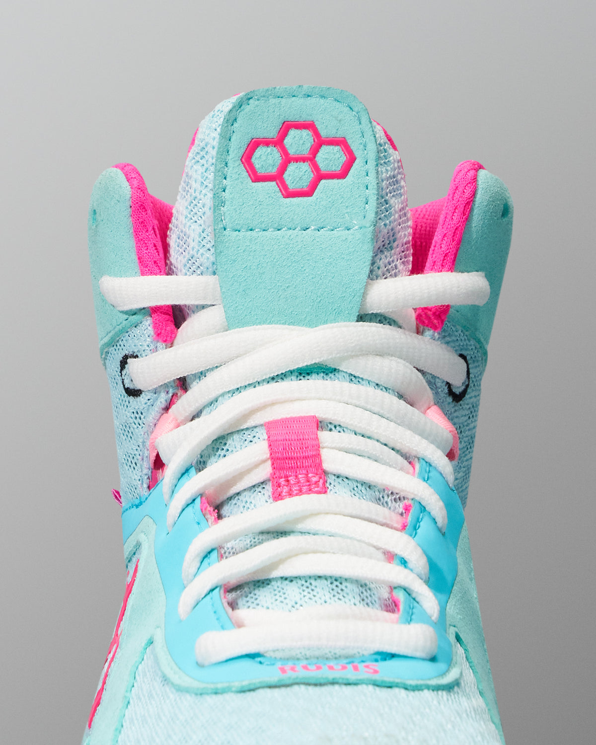 Light blue and pink Wrestling Shoe with white laces on a gray background