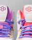Pair of colorful wrestling shoes with purple, pink, and red accents on a gray background