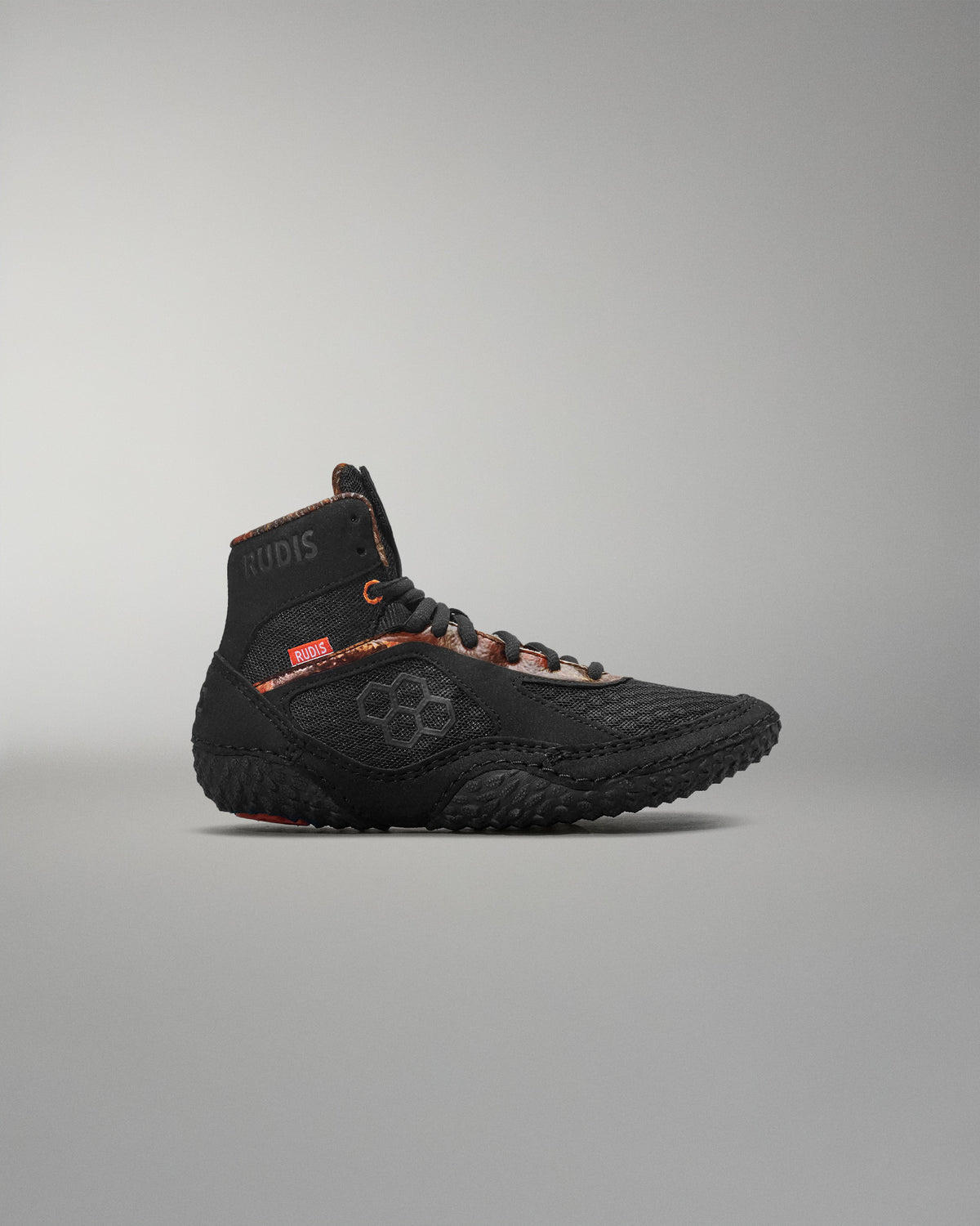 Black high-top sneaker on a gray background