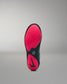 Black and pink sole of a wrestling shoe on a gray background