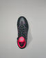 Black and pink wrestling shoe on a gray background