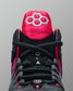 Black and pink wrestling shoe with a prominent brand logo on a gray background