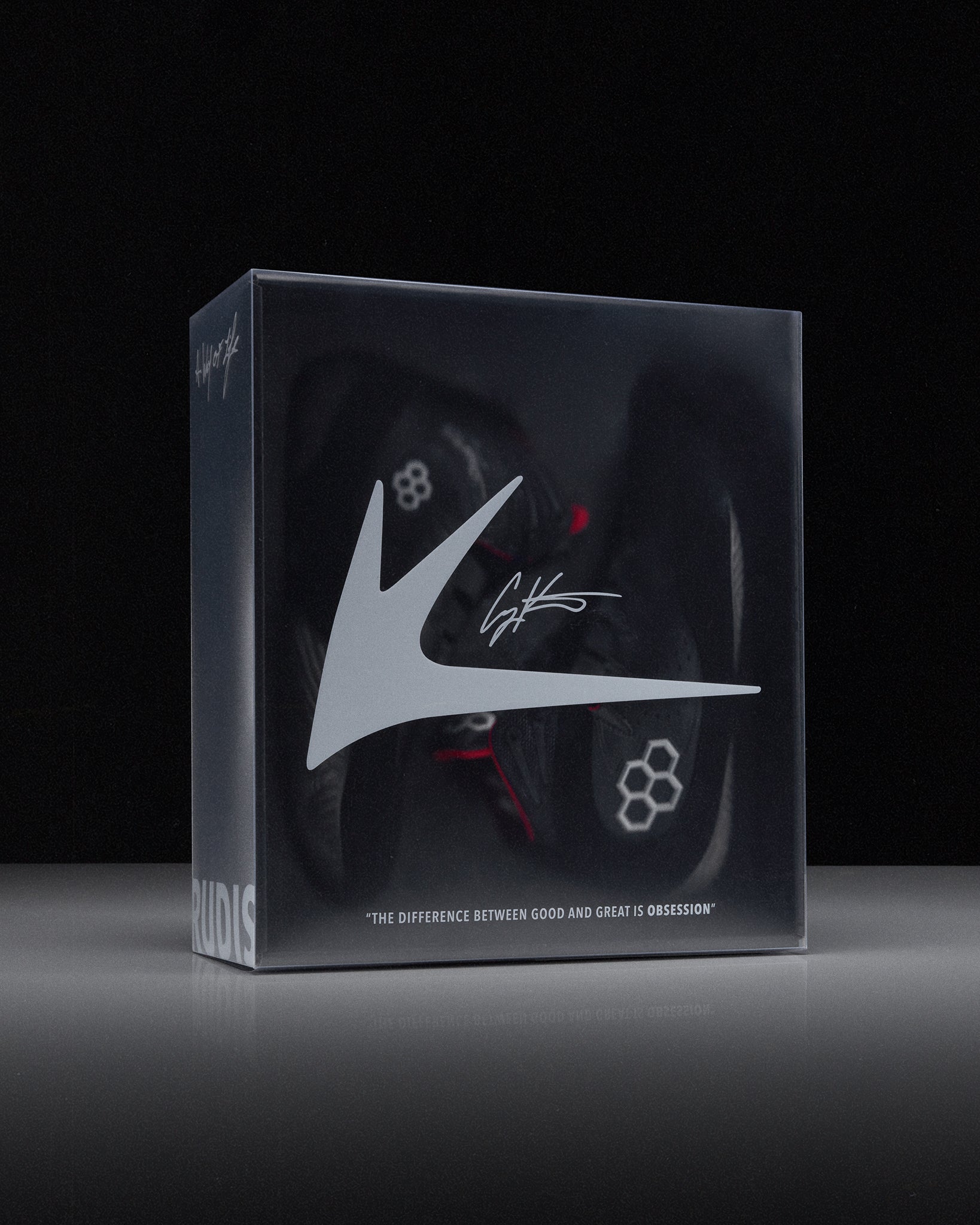 Box with wrestling shoes and a 'RUDIS' brand logo on a black background
