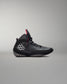 Black wrestling shoes with a red accent on a gray background