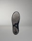 Black wrestling shoe sole with a brand logo on a gray background