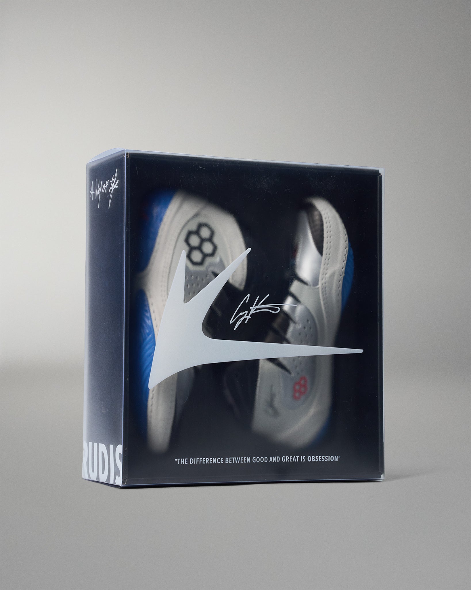 wrestling shoe in packaging with visible brand logo on a gray background