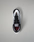 Black and white wrestling shoe with red accents on a gray background