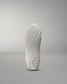 The outsole of a white athletic shoe showcases intricate patterns for traction, highlighted against a light gray background.