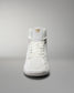 A high-top athletic shoe in white showcases a simple design with a gold logo on the tongue, set against a gradient background.