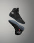 Black high-top wrestling shoe with brand logo on a gray background